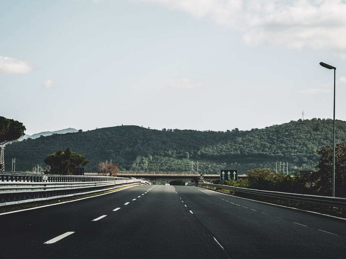 The autostrada A4 corridor heading west from Verona toward the south shore of Lake Garda